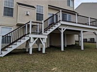 <b>Trex Transcend Spiced Rum Deck Boards with Trex composite railing in matching Spiced Rum with white composite posts and black aluminum balusters in Ellicott City MD</b>